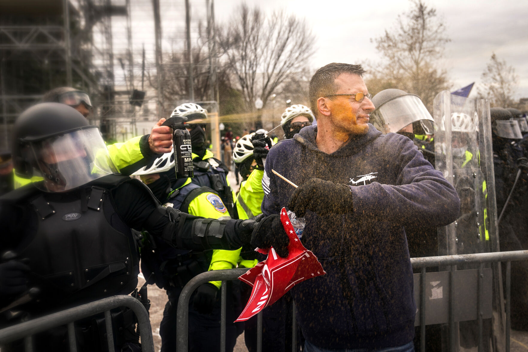 Police pepper spray a man